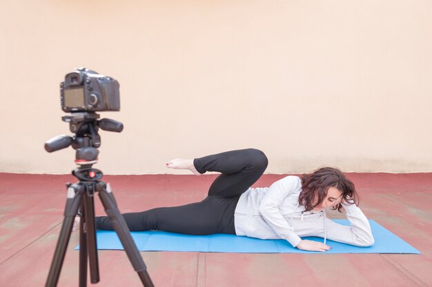 Brunette blogger recording yoga routine