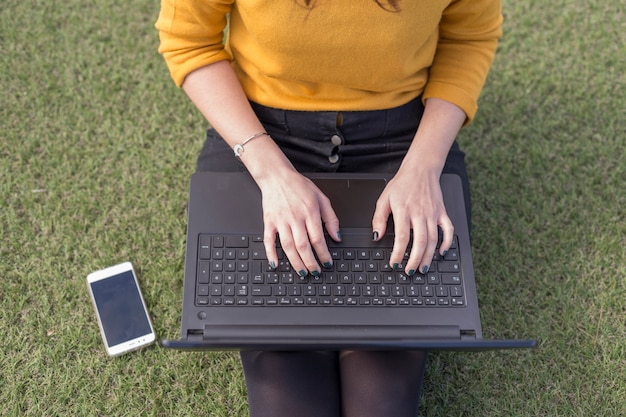 Brunette blogger writing on the laptop
