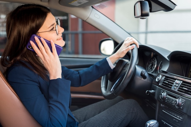 Brunette businesswoman driving