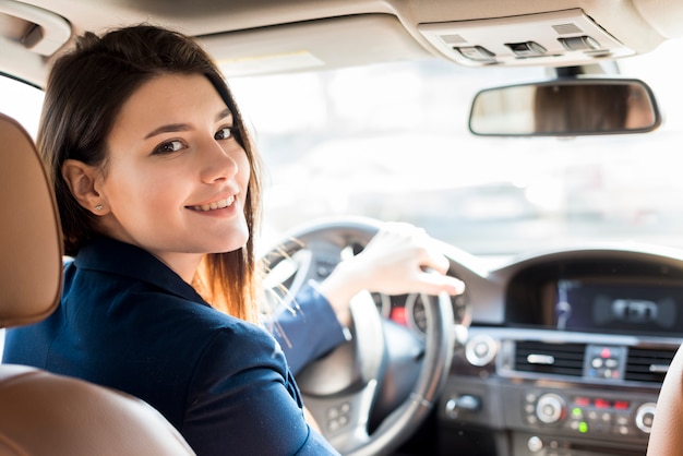 Brunette businesswoman driving