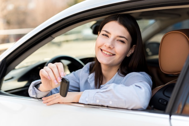 Brunette businesswoman inside a car