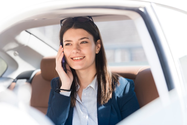 Brunette businesswoman inside a car