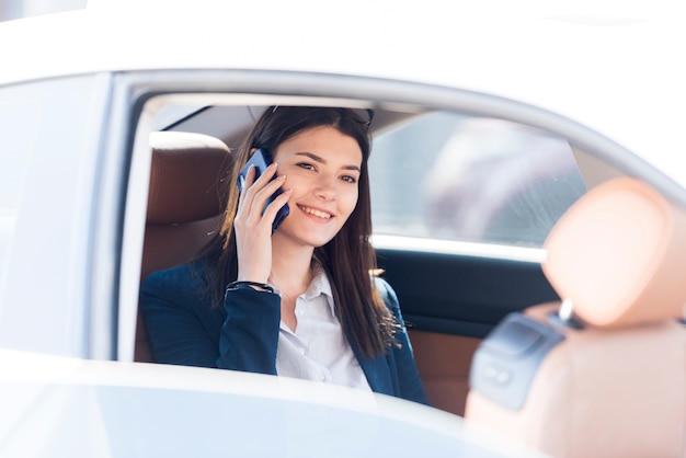 Brunette businesswoman inside a car