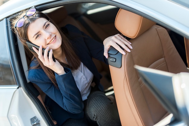 Brunette businesswoman inside a car