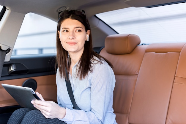 Brunette businesswoman inside a car