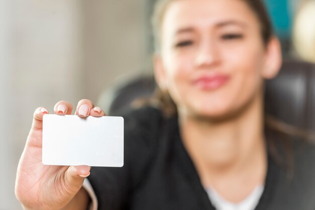 Brunette businesswoman showing card