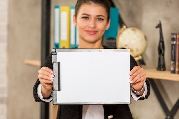 Brunette businesswoman showing paper