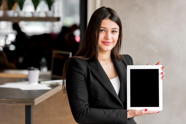 Brunette businesswoman showing tablet