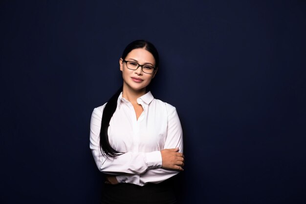 Brunette businesswoman in white blouse posing