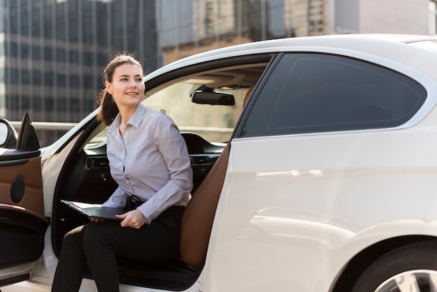 Brunette businesswoman with car