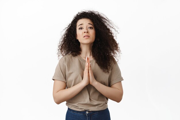 brunette curly woman asking help on white