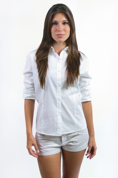 Brunette female wearing white outfit posing