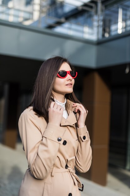 Brunette girl in casual clothes walk around city center in daytime