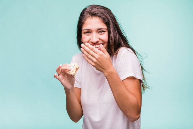 Brunette girl eating pastry