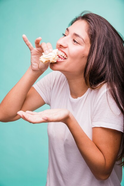 Brunette girl eating pastry