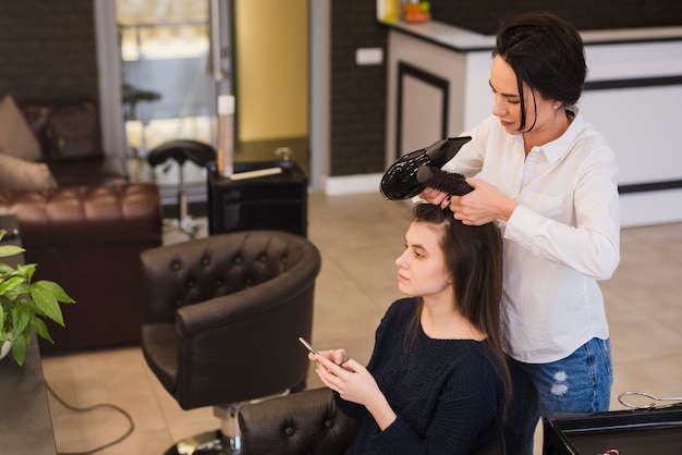 Brunette girl getting her hair done