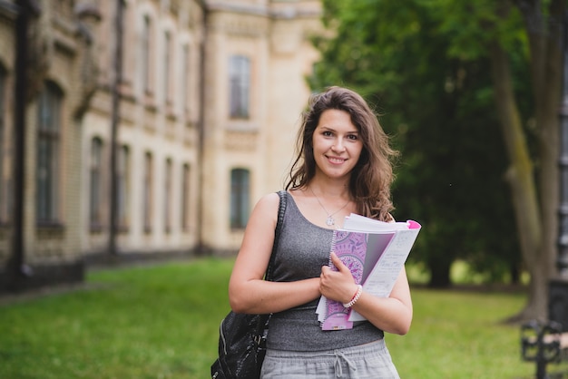 Free photo brunette girl holding card boards standing