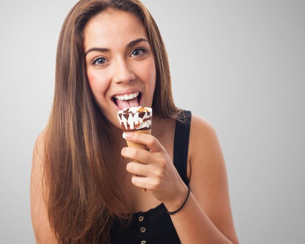아이스크림을 핥는 갈색 머리 소녀.