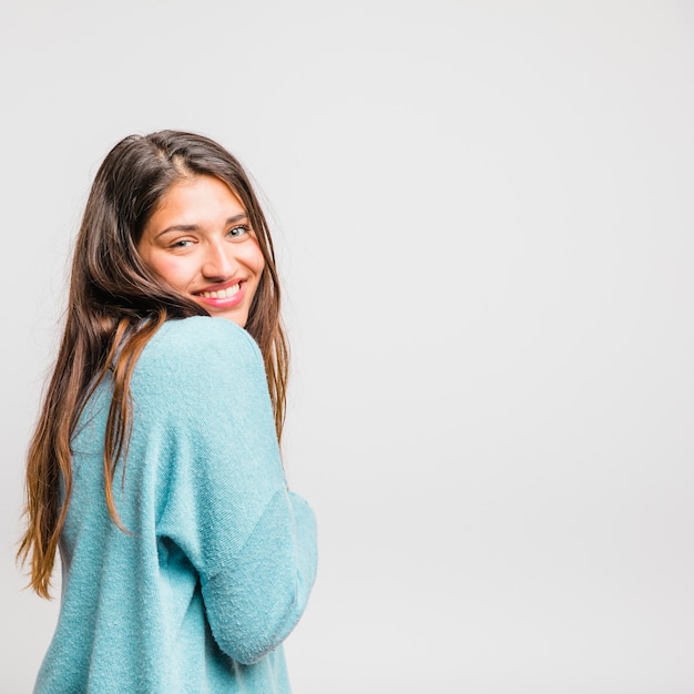 Brunette girl posing with blue sweater