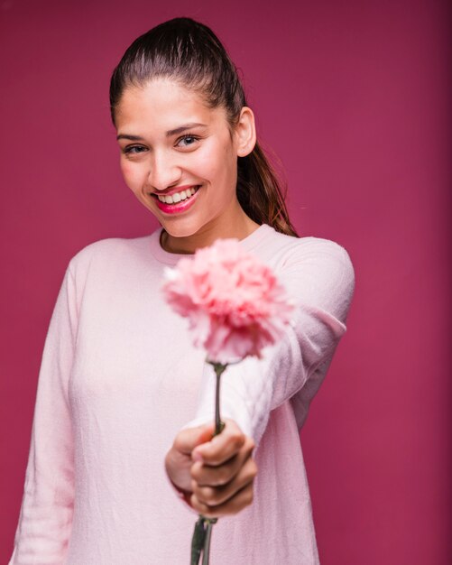 Brunette girl posing with carnation