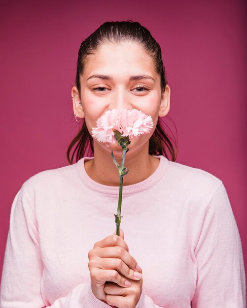 Brunette girl posing with carnation