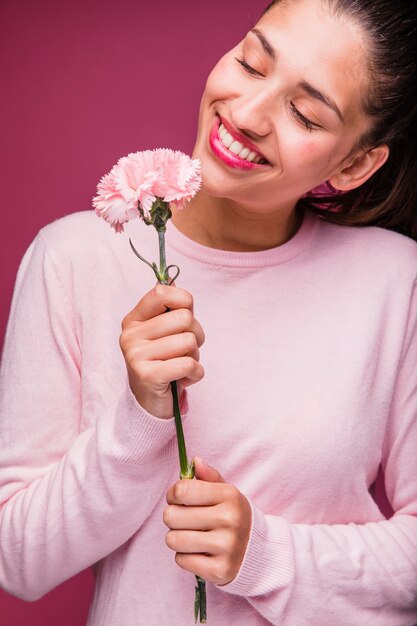 Brunette girl posing with carnation