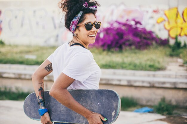 Brunette girl posing with skateboard