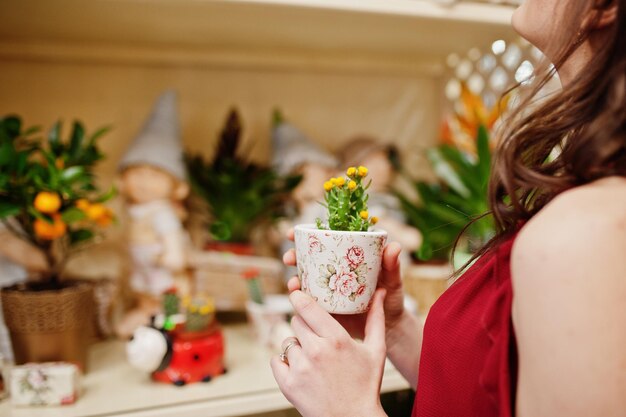 赤いブルネットの女の子は花屋で花を買う