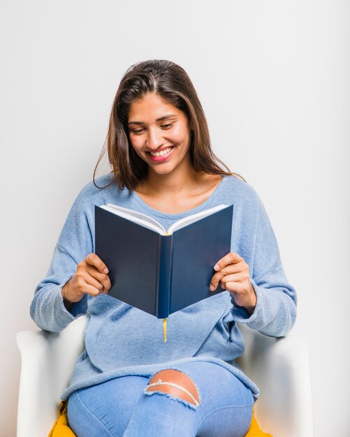 Brunette girl sitting reading a book