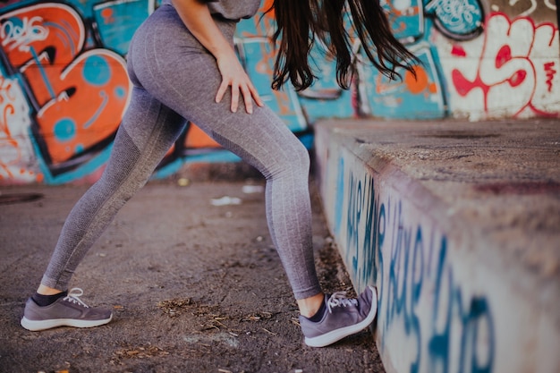 Brunette girl stretching standing outside