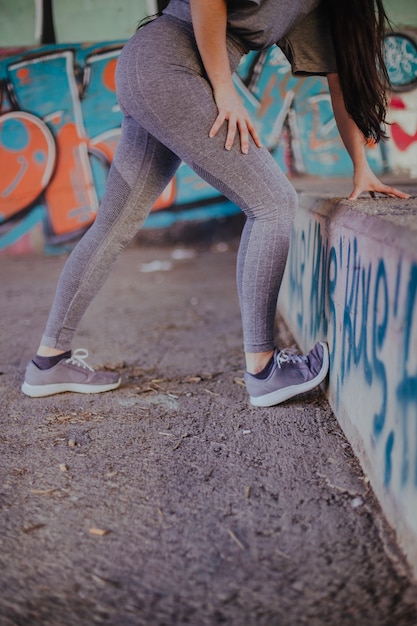 Brunette girl stretching standing outside