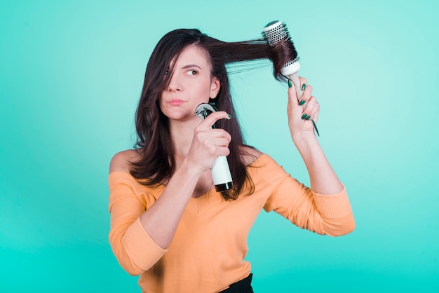 Free photo brunette girl taking care of her hair