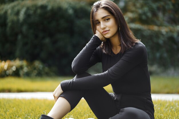 brunette girl walking through the park during autumn