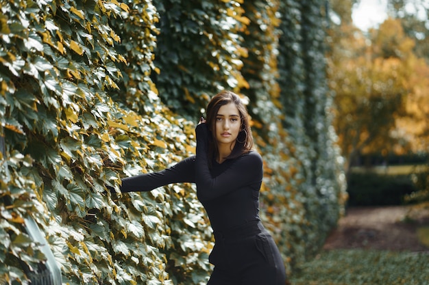 brunette girl walking through the park during autumn