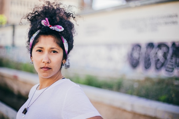 Brunette girl wearing headband standing outside