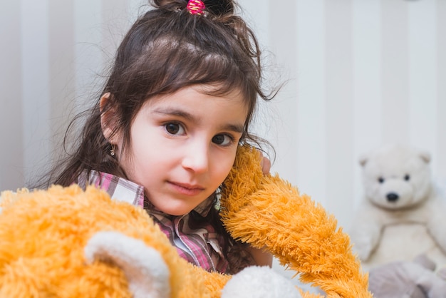 Brunette girl with plush toy 