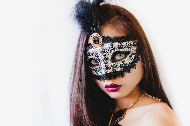 Brunette girl with a white venetian mask