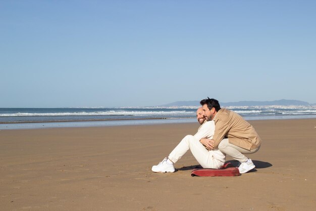 Brunette man embracing boyfriend at date