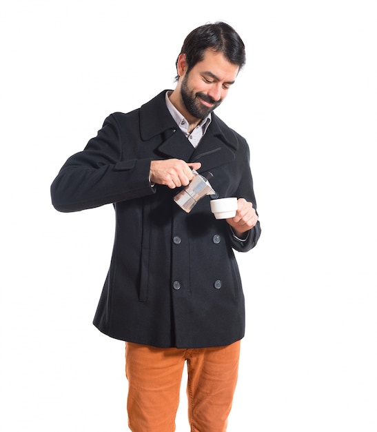 Free photo brunette man holding a cup of coffee