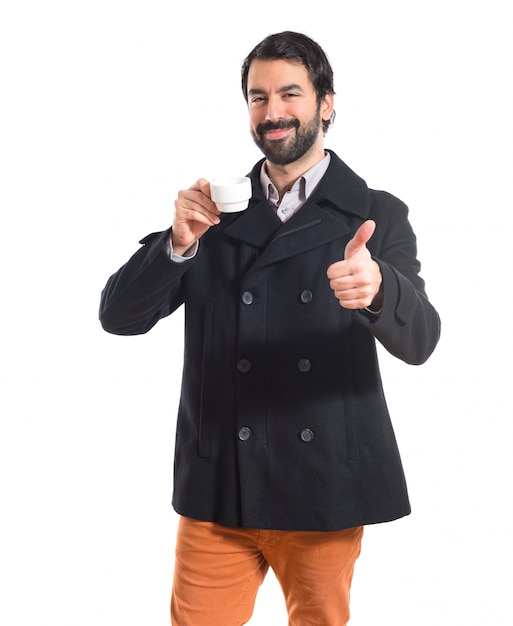 Free photo brunette man holding a cup of coffee