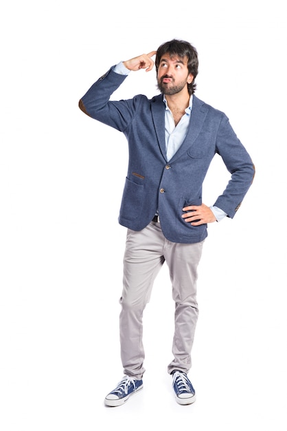 Brunette man thinking over isolated white background