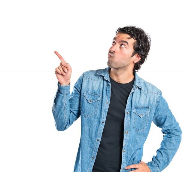 Brunette man thinking over isolated white background