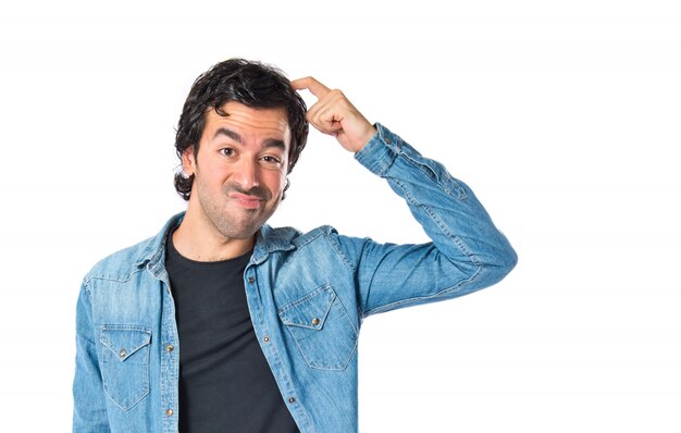 Brunette man thinking over isolated white background