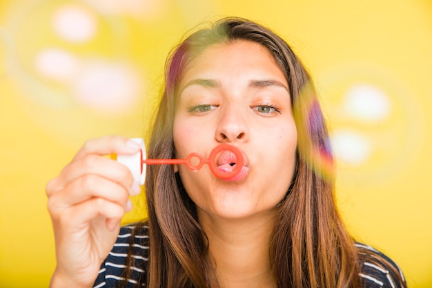 Brunette model blowing bubbles