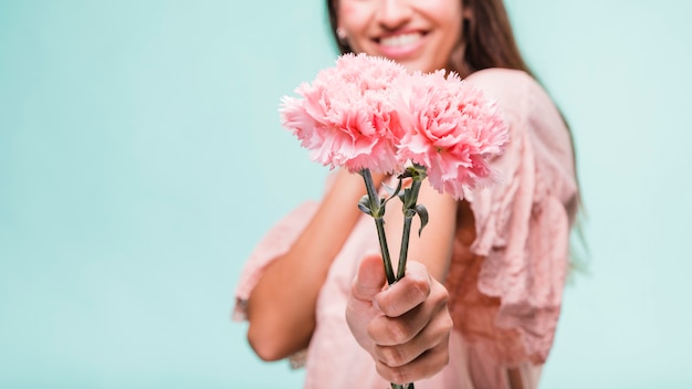 Brunette model posing with carnation