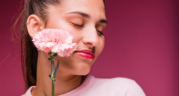 Brunette model posing with carnation
