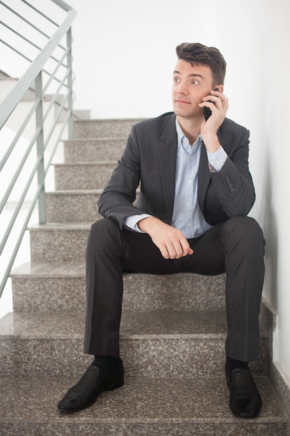 brunette sitting stairs corridor career