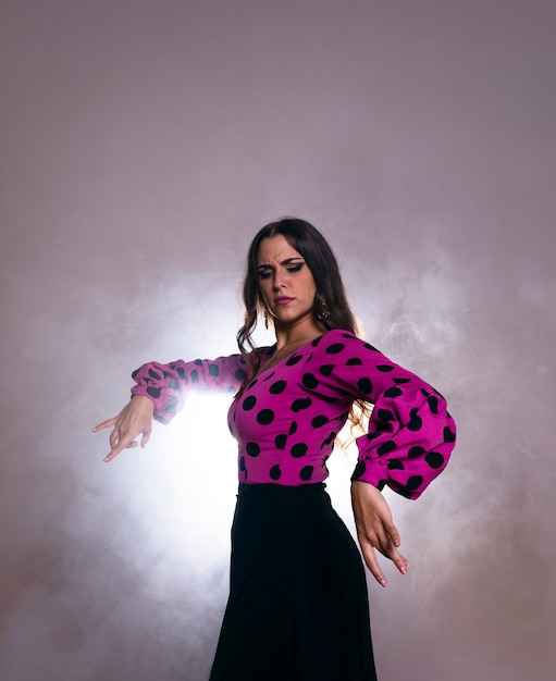 Brunette woman dancing with light on the back