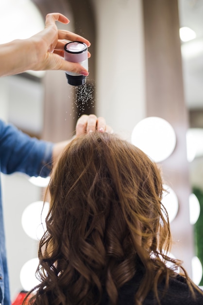 Foto gratuita donna castana che fa i suoi capelli fatti