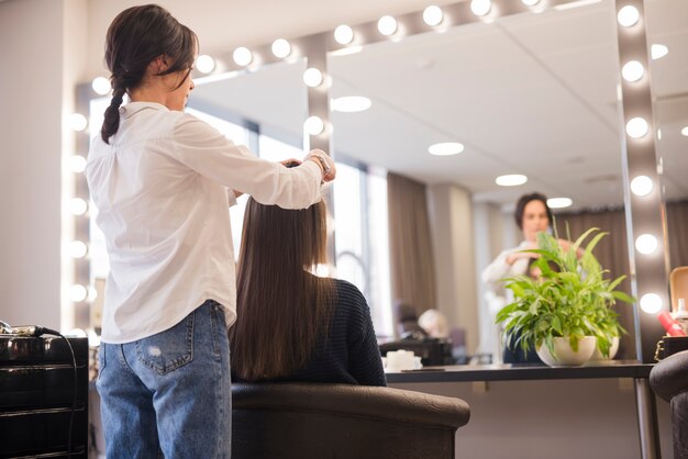 brunette woman getting her hair done
